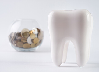 tooth next to a jar full of coins