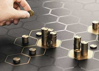 Person organizing coins onto glowing hexagons