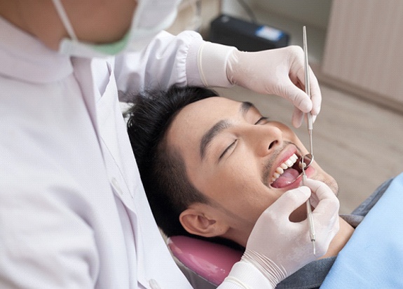 a patient undergoing a dental checkup in Fresno