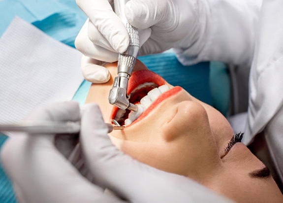 a dentist performing a dental checkup in Fresno