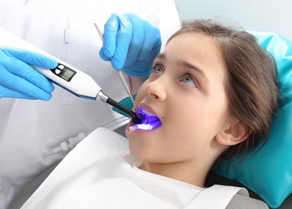 Child receiving dental sealant treatment