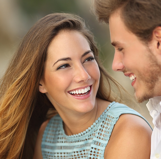 Couple smiling together on beach pier