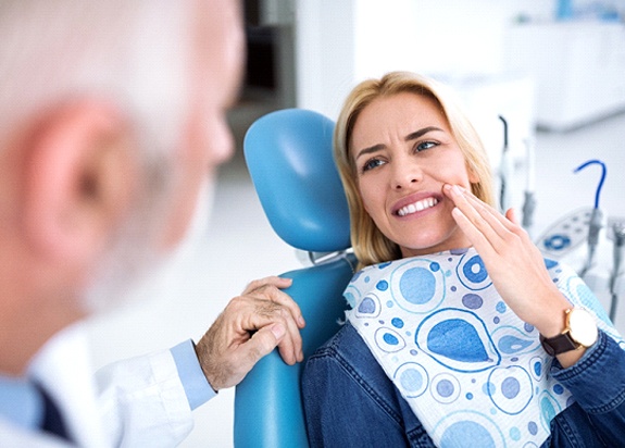 Woman showing dentist hurting tooth