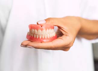 Woman with dentures in Fresno smiling