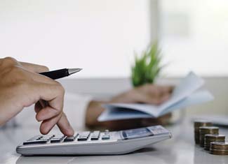 Man calculating cost of dentures in Fresno