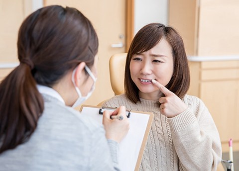 Woman speaking to an emergency dentist in Fresno