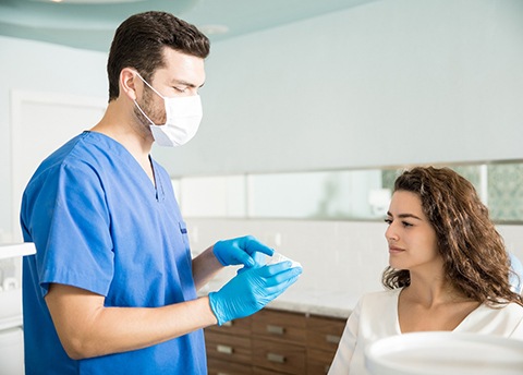 Dentist explaining how to prevent dental emergencies in Fresno