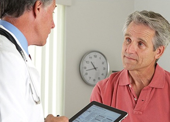 man talking to his dentist about the cost of emergency dentistry in Fresno