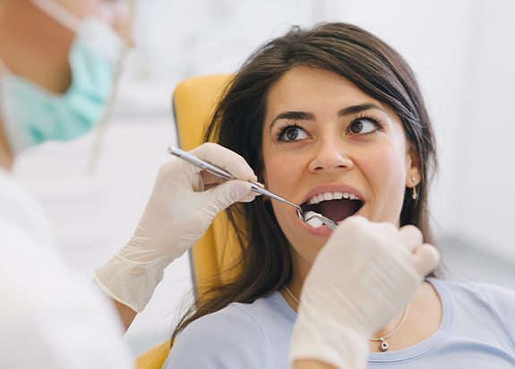 Woman receiving tooth extraction