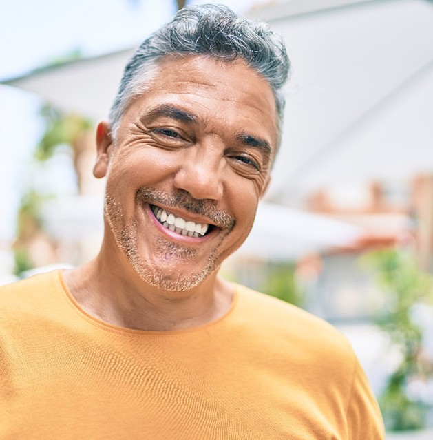 A middle-aged, gray-haired man smiling