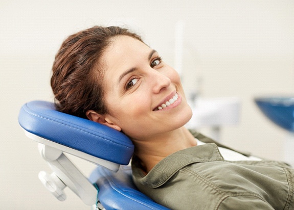 Woman learning dental implant care in Fresno