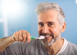 Man brushing teeth in Fresno