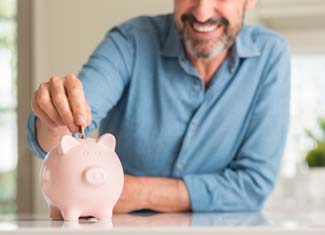 Man putting money in piggy bank in Fresno 