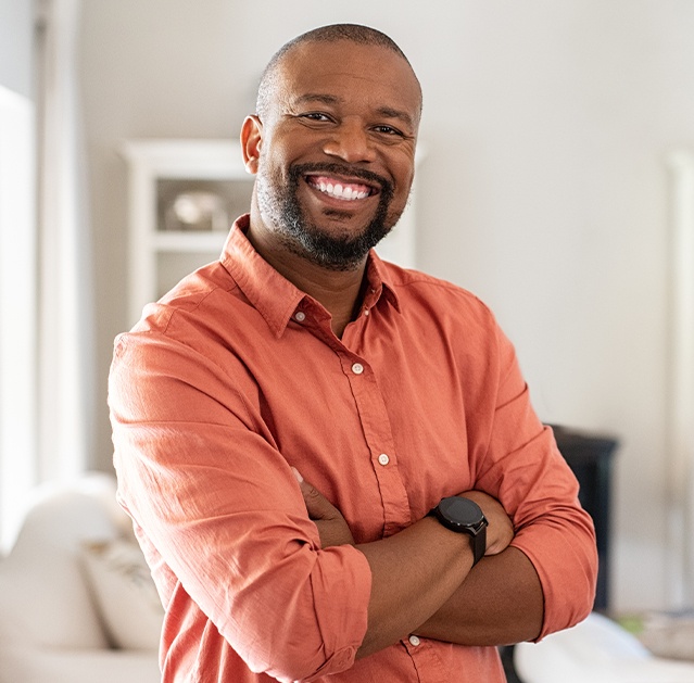 Man sharing healthy smile after dental implant retained dentures