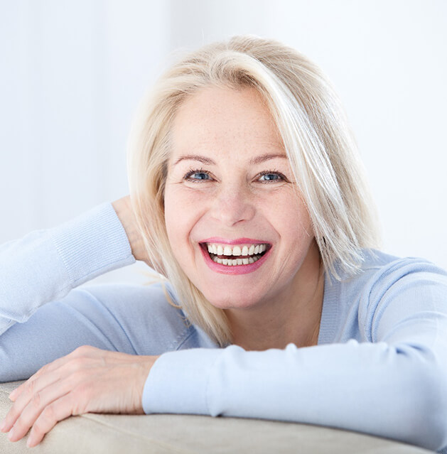 older woman smiling with dental implants in Fresno