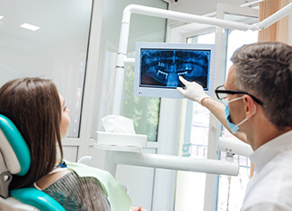 dentist showing a patient their X-rays