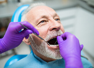 dentist examining a patient’s mouth