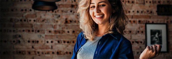 Smiling woman wearing blue button shirt