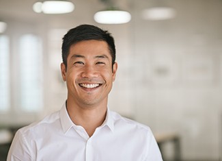 Man in white button-up shirt smiling