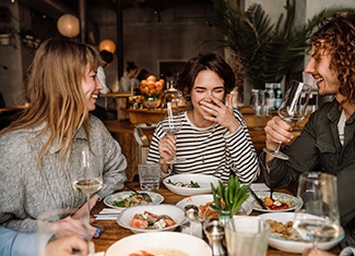 Group of friends enjoying meal together at restaurant