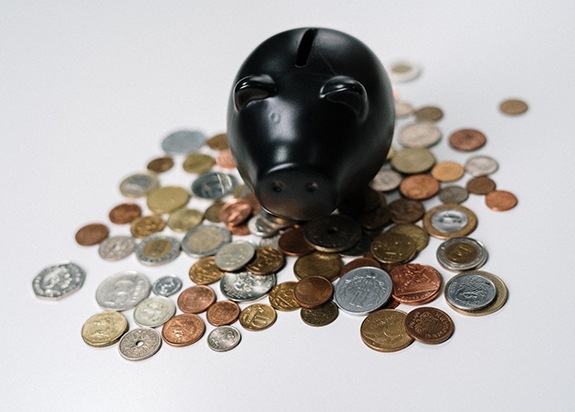 Black piggy bank and loose coins