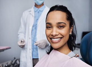 a patient smiling while visiting her dentist