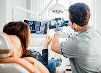 Dentist and patient reviewing X-ray during appointment