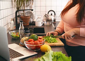 Patient preparing nutrient-dense meal in kitchen