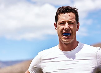 Man wearing mouthguard while hiking outside
