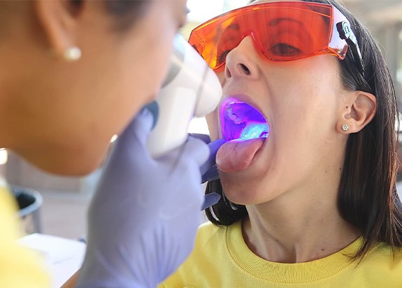 Dentist performing oral cancer screening