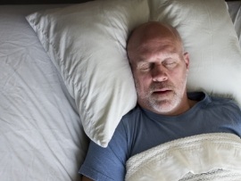 Man sleeping soundly thanks to sleep apnea therapy