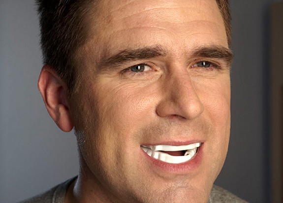 Man with sleep apnea appliance in place