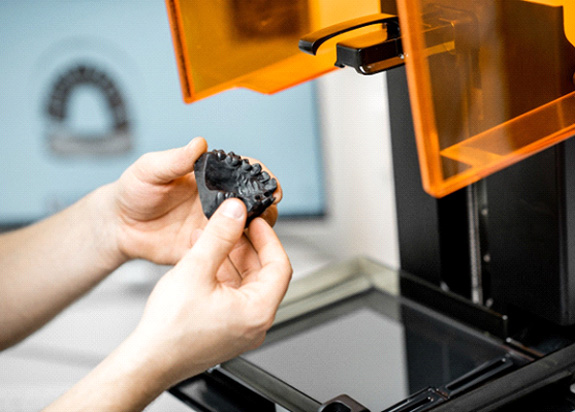 dentist holding 3D printed impression