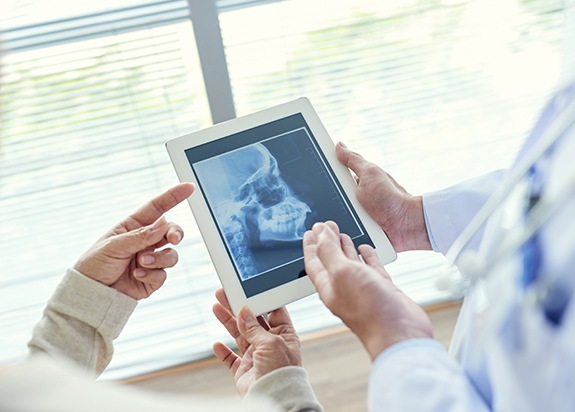 Dentist reviewing digital x-rays during T M Jdiagnosis and treatment planning