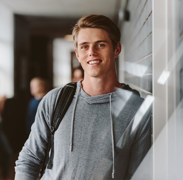 Young man with healthy smile after wisdom tooth extraction