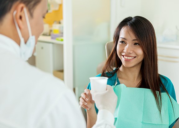 Woman discussing wisdom tooth extraction after care with her dentist