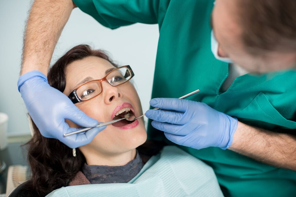 Woman in glasses undergoing dental exam