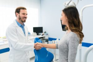 Dentist and patient shaking hands