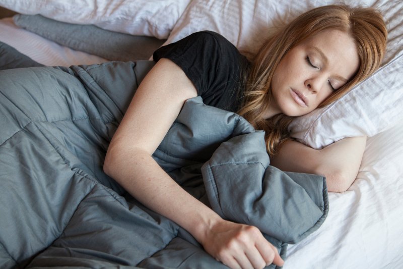 A woman sleeping with a weighted blanket
