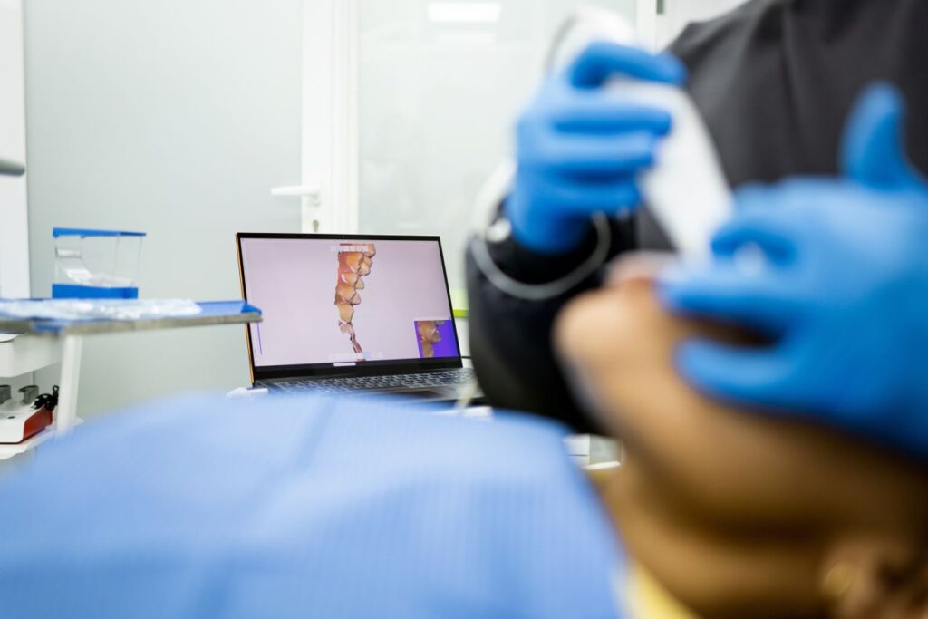 A dentist taking digital impressions of a patient’s mouth