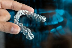 man holding invisalign