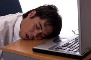 man asleep at desk drooling